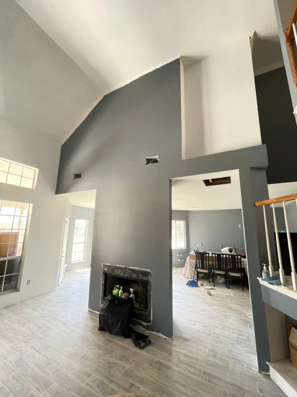 Accent wall painting in Sugar Land, TX with a charcoal fireplace surround in a living room