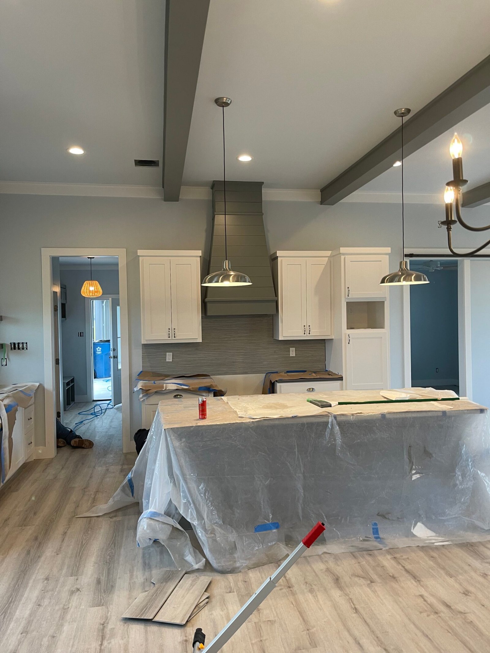 Kitchen cabinet painting in Cypress, TX with cabinets and walls masked and sprayed