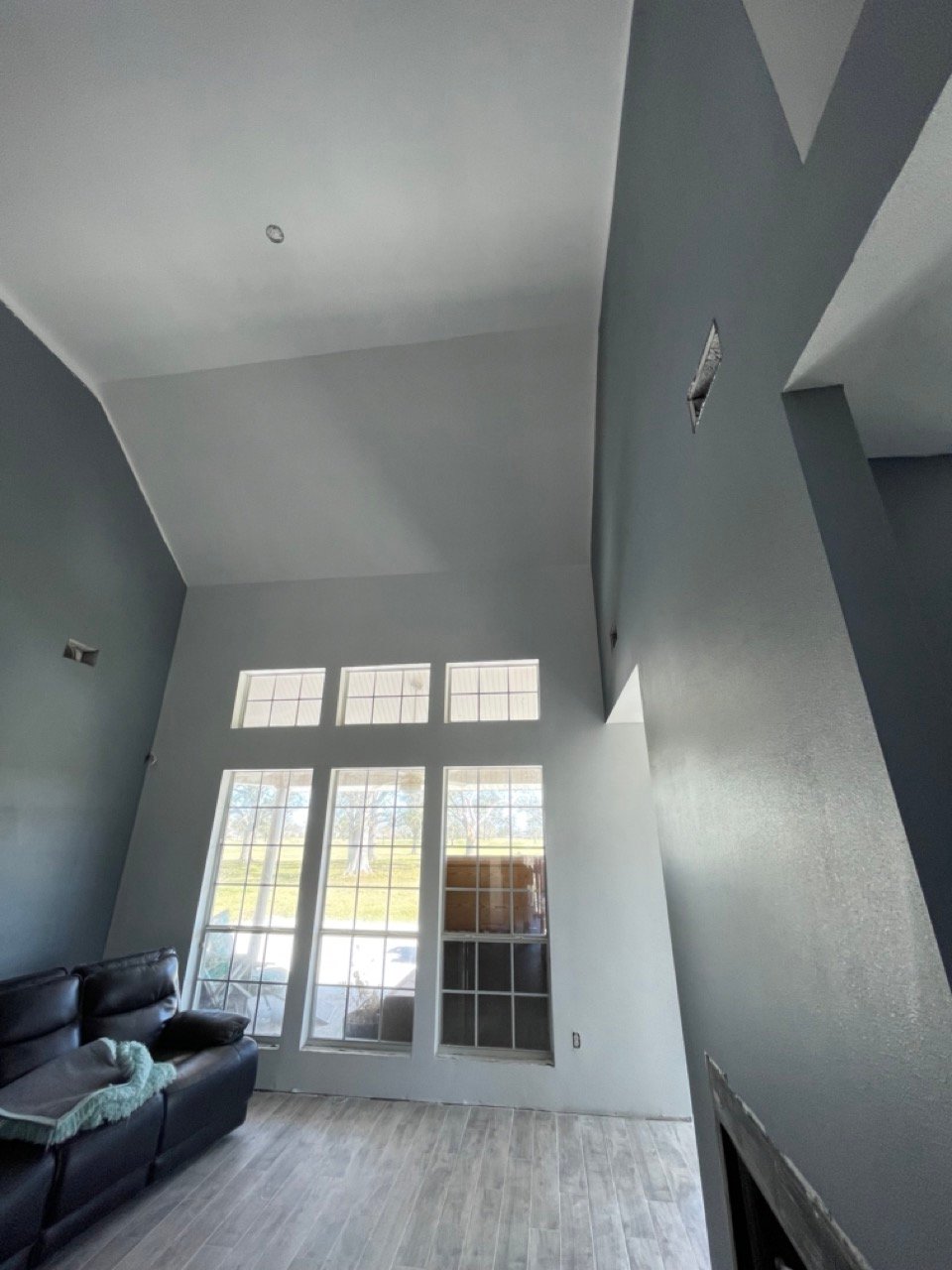 Sheetrock repair in The Woodlands, TX on a two-story entry with smooth walls and fresh paint